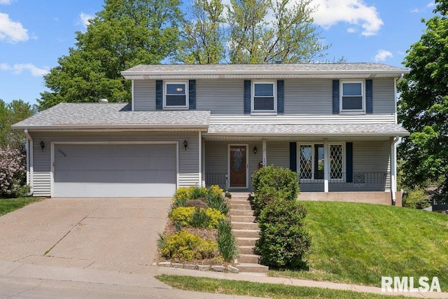 view of front of house featuring a garage, covered porch, driveway, and a front yard