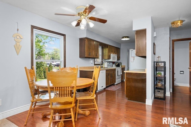 dining space featuring ceiling fan, wood finished floors, and baseboards