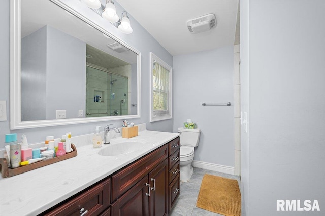full bathroom featuring a shower stall, toilet, vanity, baseboards, and tile patterned flooring