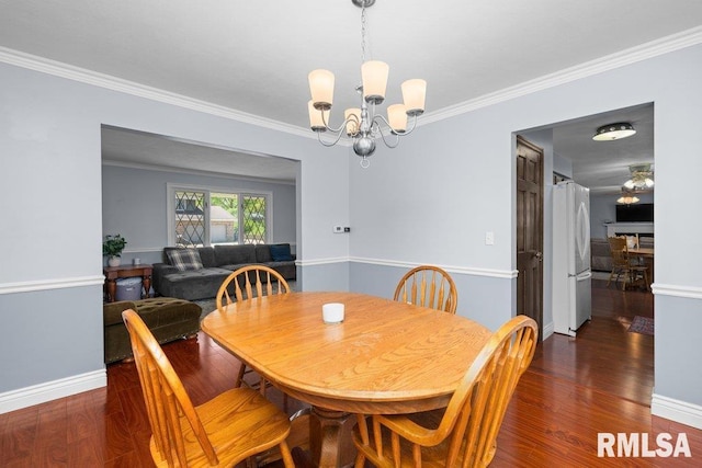 dining room with a chandelier, crown molding, wood finished floors, and baseboards