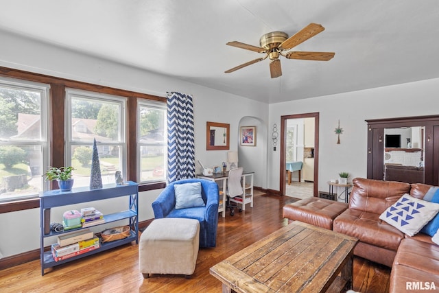 living area with ceiling fan, wood finished floors, and baseboards