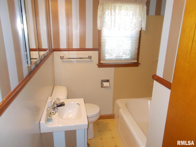 615 N 4th St, Clinton, IA 52732 - full bath with toilet, a bathtub, baseboards, a sink, and tile patterned floors