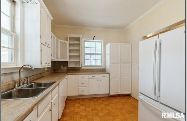 kitchen with white appliances, a sink, open shelves, crown molding, and white cabinetry