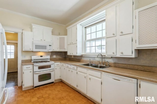 kitchen with white appliances, a sink, ornamental molding, white cabinetry, and light countertops