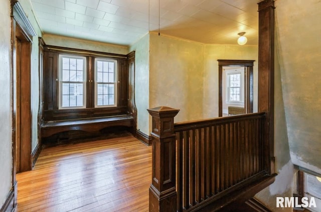 stairs featuring hardwood / wood-style flooring, crown molding, and baseboards