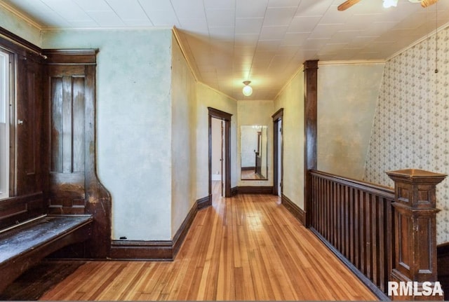 corridor with crown molding, hardwood / wood-style floors, and baseboards