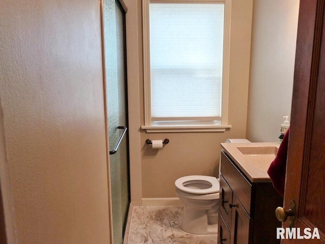 full bathroom with vanity, toilet, a stall shower, baseboards, and marble finish flooring