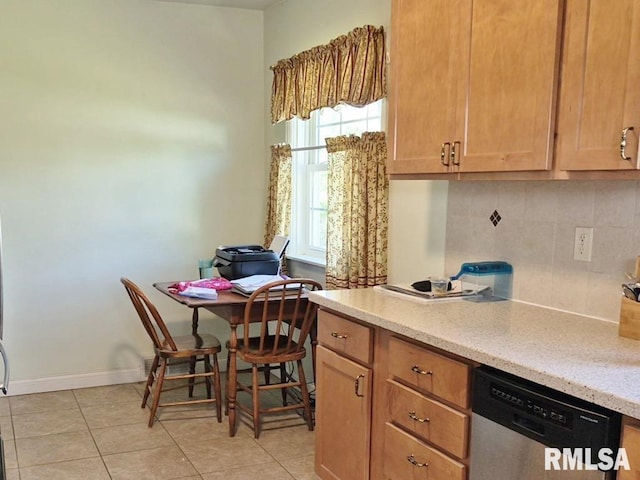 kitchen featuring dishwasher, decorative backsplash, light tile patterned floors, and light stone counters