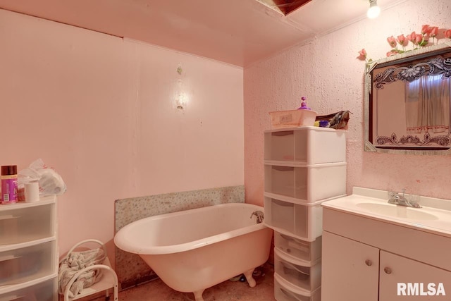 bathroom with a freestanding tub and vanity