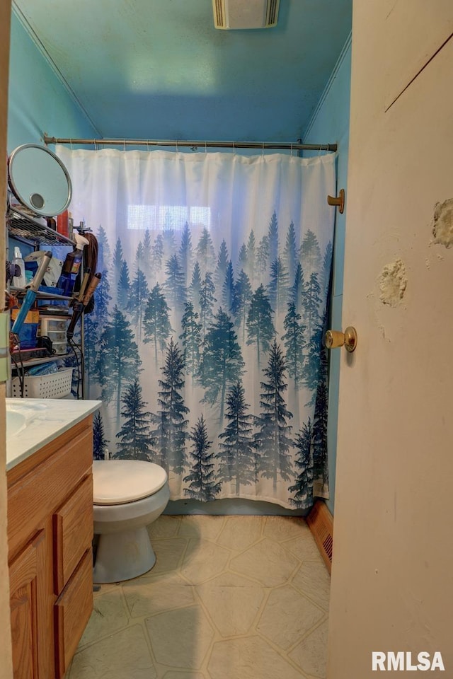 bathroom with vanity, ornamental molding, toilet, and curtained shower