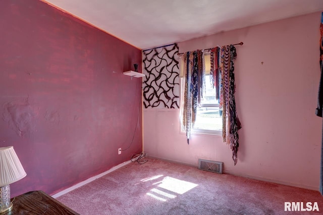 carpeted spare room with baseboards