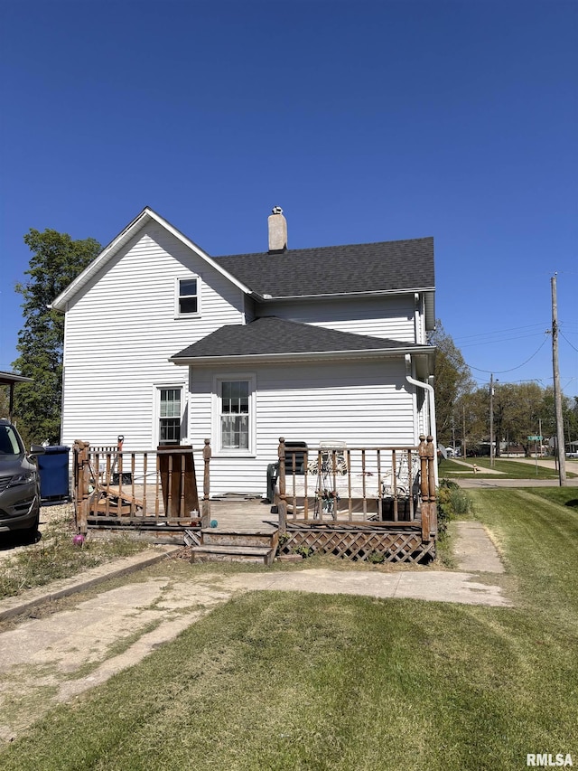 451 S Grove St, Kewanee, IL 61443 - back of house with a chimney, a lawn, a wooden deck, and roof with shingles