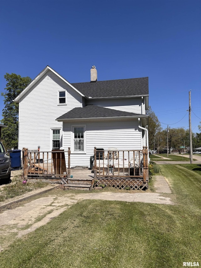 451 S Grove St, Kewanee, IL 61443 - back of house with a chimney, a wooden deck, roof with shingles, and a lawn