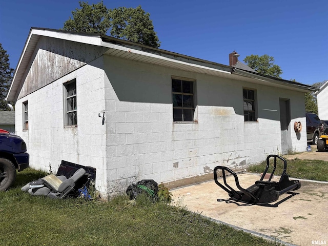 451 S Grove St, Kewanee, IL 61443 - view of home's exterior with concrete block siding and a lawn