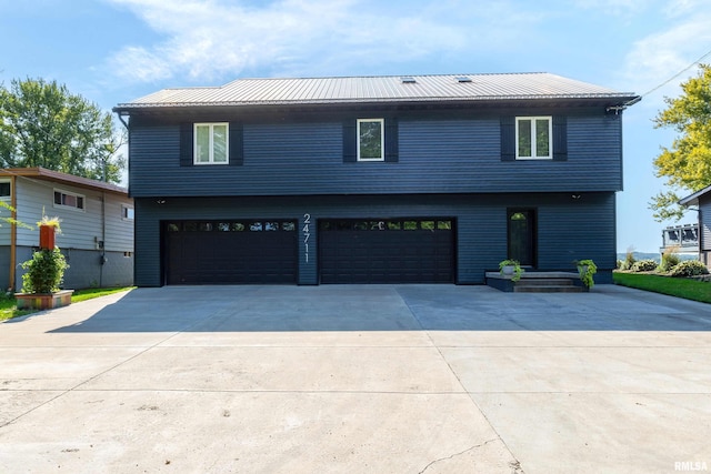 24711 178th St, Pleasant Valley, IA 52767 - view of front of property featuring an attached garage, driveway, and metal roof