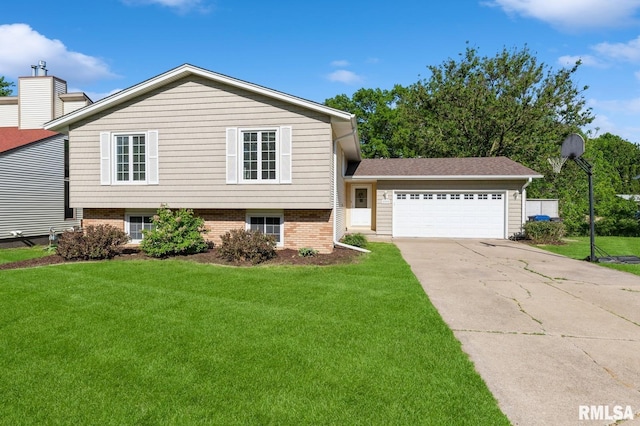 2885 Willow Dr, Bettendorf, IA 52722 - tri-level home with a front yard, a garage, and driveway