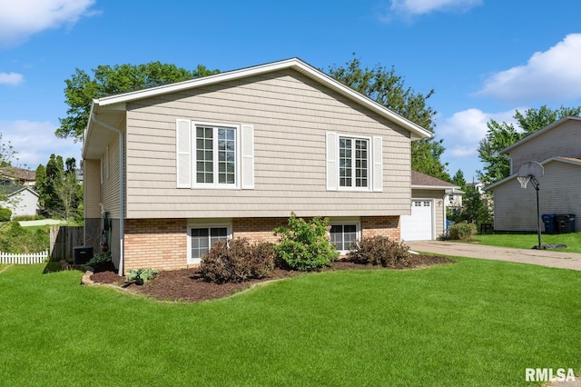 2885 Willow Dr, Bettendorf, IA 52722 - view of home's exterior featuring driveway, central AC, brick siding, and a garage