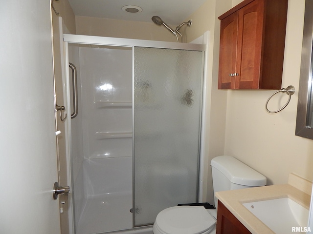 full bathroom with a stall shower, toilet, and vanity
