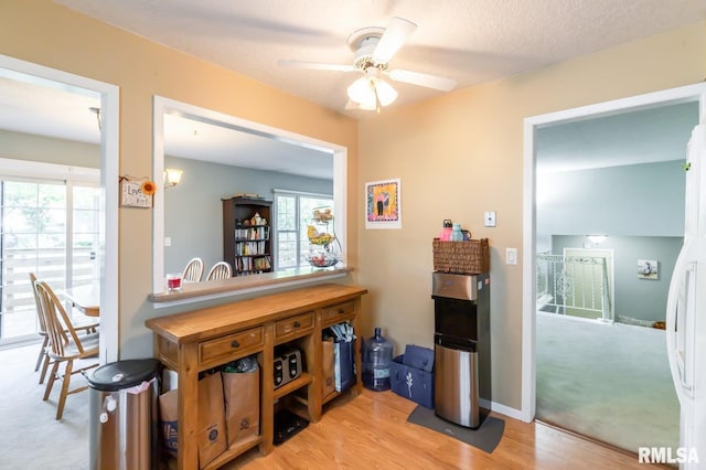 2885 Willow Dr, Bettendorf, IA 52722 - bar area with plenty of natural light, ceiling fan, and light wood-style flooring