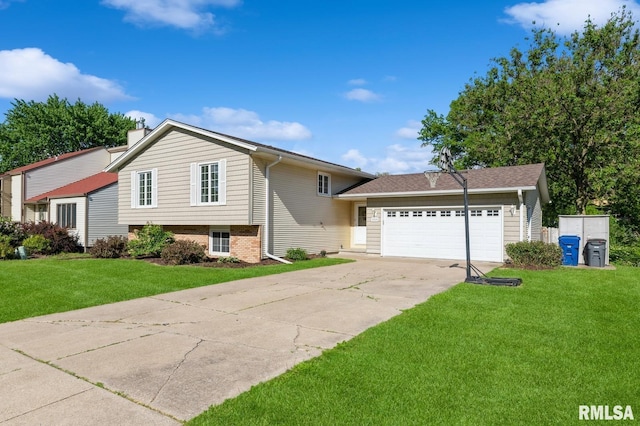 2885 Willow Dr, Bettendorf, IA 52722 - tri-level home with a garage, driveway, a front lawn, and a chimney