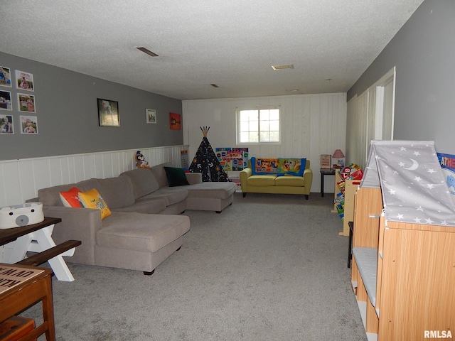 living room featuring carpet flooring and a textured ceiling