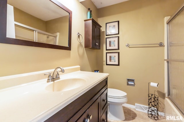 2885 Willow Dr, Bettendorf, IA 52722 - bathroom featuring a shower with door, toilet, tile patterned flooring, vanity, and baseboards
