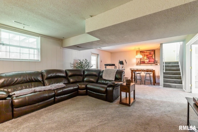 2885 Willow Dr, Bettendorf, IA 52722 - living room with carpet flooring, a textured ceiling, plenty of natural light, and stairway