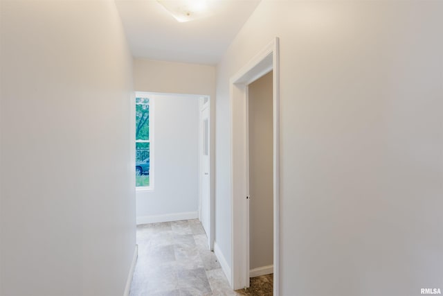 corridor featuring baseboards