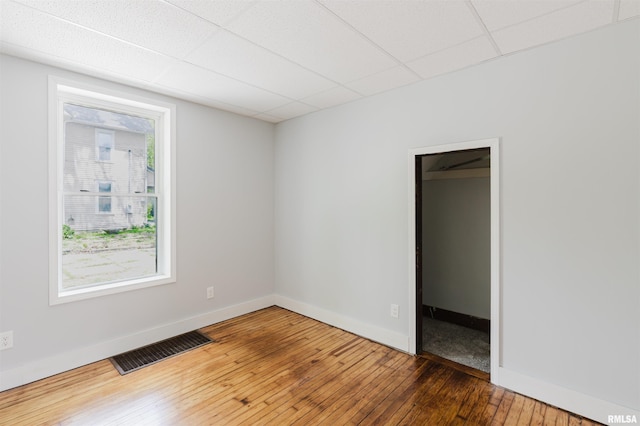 empty room featuring hardwood / wood-style floors and baseboards