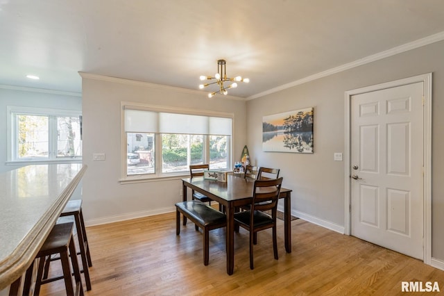1 Kenwood Ave, Davenport, IA 52803 - dining area featuring a chandelier, crown molding, light wood finished floors, and baseboards