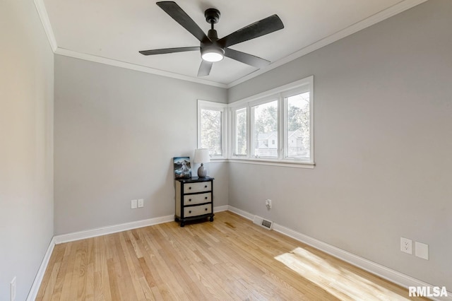 1 Kenwood Ave, Davenport, IA 52803 - spare room with light wood finished floors, baseboards, crown molding, and a ceiling fan