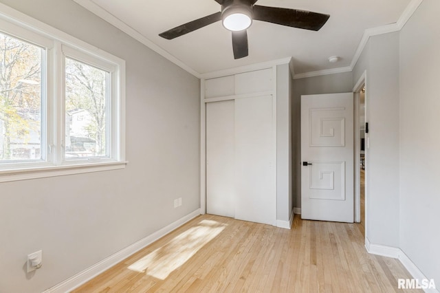 1 Kenwood Ave, Davenport, IA 52803 - unfurnished bedroom featuring light wood-style flooring, ornamental molding, a closet, baseboards, and ceiling fan