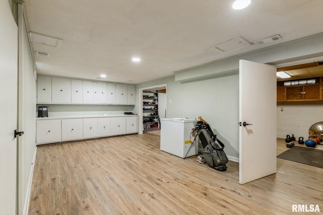1 Kenwood Ave, Davenport, IA 52803 - below grade area featuring light wood-style flooring, fridge, and recessed lighting