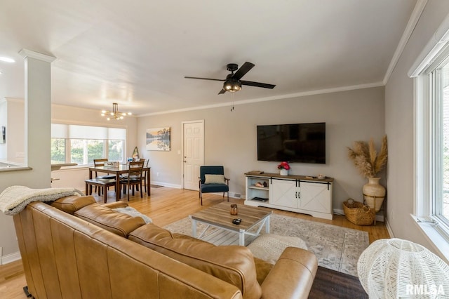 1 Kenwood Ave, Davenport, IA 52803 - living room with a chandelier, wood finished floors, baseboards, and crown molding