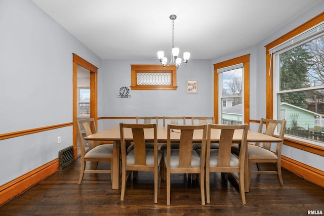 2307 N Ripley St, Davenport, IA 52803 - dining area with a chandelier, wood finished floors, and baseboards