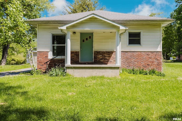 602 Barr St, Carterville, IL 62918 - bungalow-style home with brick siding, roof with shingles, a front lawn, and covered porch