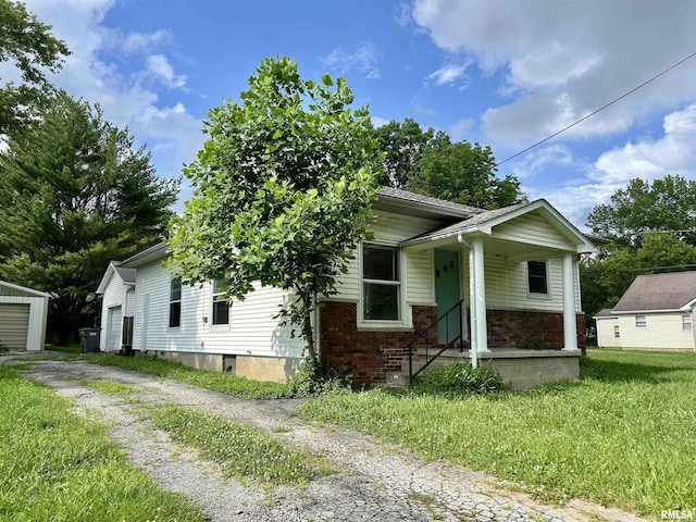602 Barr St, Carterville, IL 62918 - view of front of property featuring covered porch, an outbuilding, brick siding, and a front yard