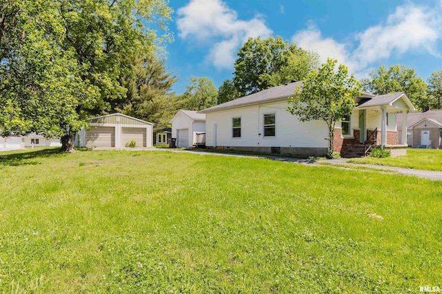 602 Barr St, Carterville, IL 62918 - view of front of house featuring a detached garage, a front lawn, and an outbuilding