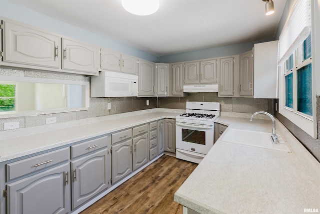 602 Barr St, Carterville, IL 62918 - kitchen featuring white appliances, gray cabinets, under cabinet range hood, a sink, and dark wood finished floors