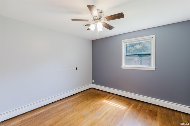 602 Barr St, Carterville, IL 62918 - spare room with baseboard heating, wood finished floors, a ceiling fan, and baseboards