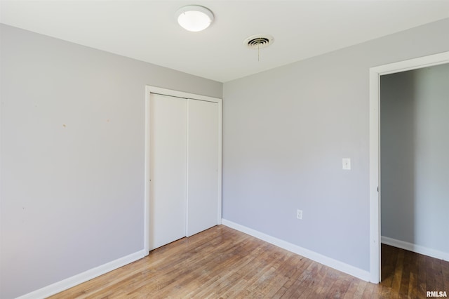 602 Barr St, Carterville, IL 62918 - unfurnished bedroom featuring a closet, light wood-type flooring, and baseboards