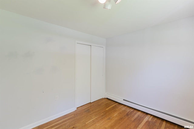 602 Barr St, Carterville, IL 62918 - spare room featuring baseboard heating, light wood finished floors, and baseboards