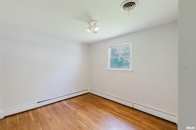 602 Barr St, Carterville, IL 62918 - unfurnished room featuring a baseboard heating unit and wood finished floors