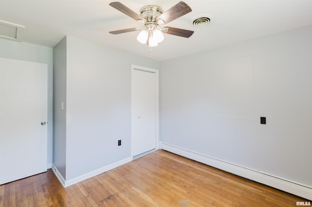 602 Barr St, Carterville, IL 62918 - unfurnished bedroom with a baseboard heating unit, attic access, light wood-style flooring, a closet, and baseboards
