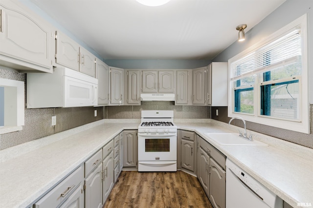 602 Barr St, Carterville, IL 62918 - kitchen with white appliances, under cabinet range hood, a sink, dark wood-style floors, and decorative backsplash