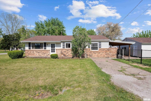 single story home featuring brick siding, a carport, and asphalt driveway