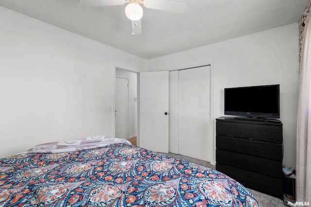 carpeted bedroom with a ceiling fan and a closet
