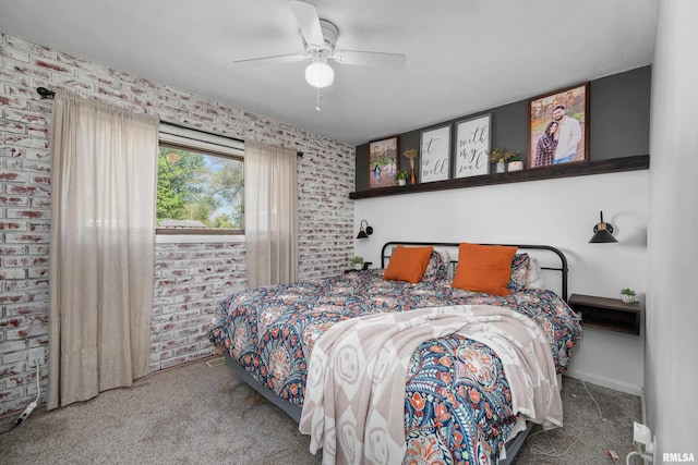 bedroom featuring baseboards, a ceiling fan, and brick wall