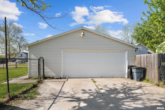 detached garage featuring fence