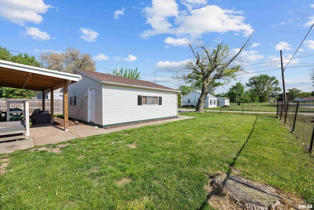 view of yard featuring a patio and an outdoor structure